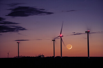 Cresecent Moon Sets Behind Wind Turbines