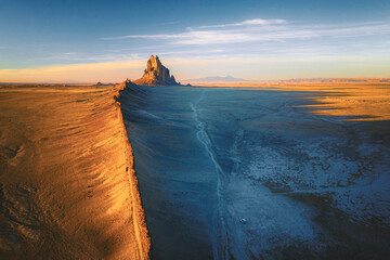 Shiprock mountain and a RV in the sunset light from above, New Mexico