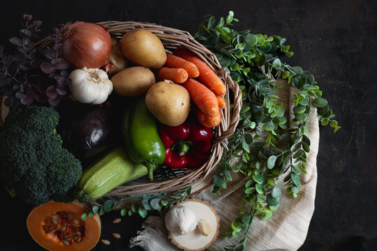 Wicker basket full of vegetables with a piece of pumpkin as the protag