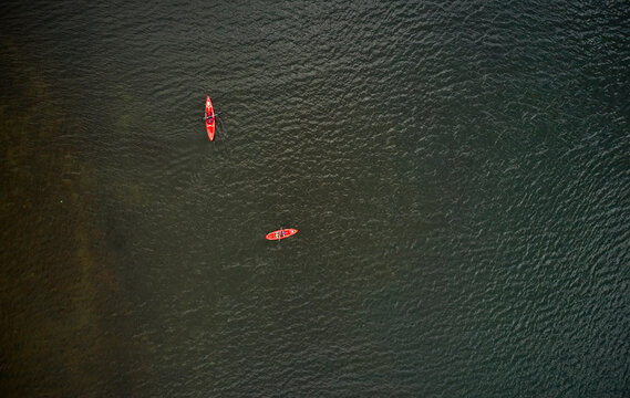 Red kayaks with travelers on lake