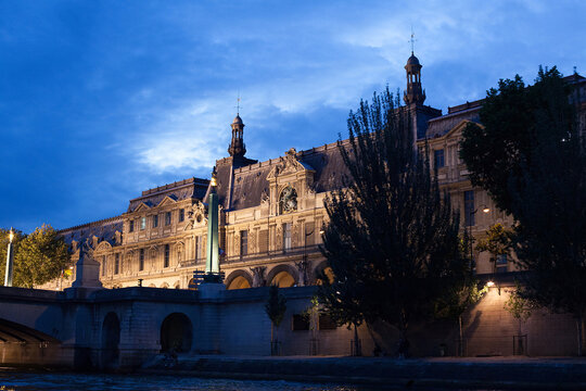 View of Old Paris Building Lit Against Cloudy Sky At Night, From Seine