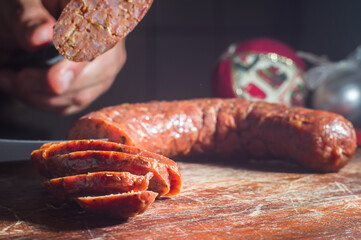 Sliced ​​smoked calabrese sausage in a wooden table,copy space
