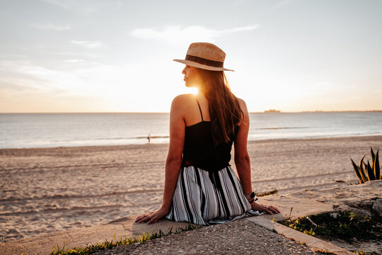 Young woman sunbathing at sunset on a beach in southern Spain