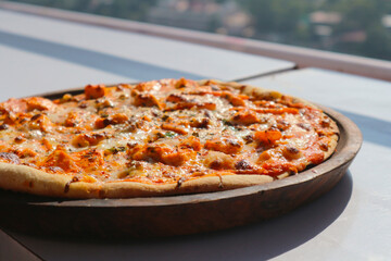 Vegetarian pizza on the veranda. Shallow depth of field.
