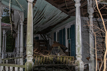 Abandoned dilapidated creepy wooden house close up side porch