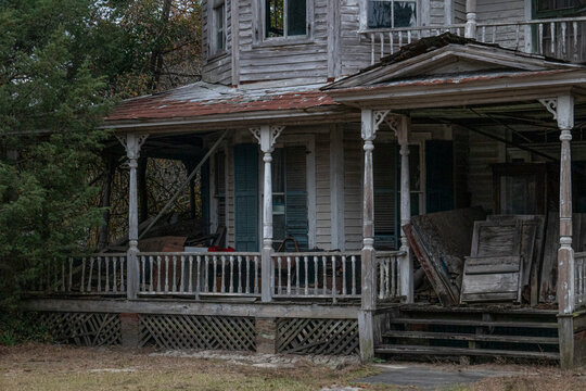 Abandoned dilapidated creepy wooden house clutter on front porch