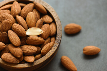 Almonds nuts on wooden bowltop view, Close up roasted almond nuts natural protein food and for snack