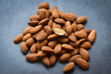 Almonds on dark background top view on the table, Close up roasted almond nuts natural protein food and for snack