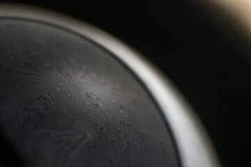 Grey alien planet in universe on dark background. Abstract closeup soap bubble