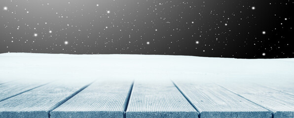 Winter Christmas scenic background with wooden table and copy space.