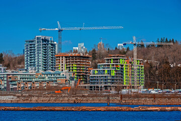 
Construction of a new high-rise buildings in the city side of the riverbank of Vancouver City
