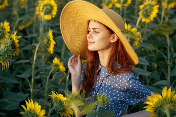 pretty woman with hat in the field of sunflowers freedom nature