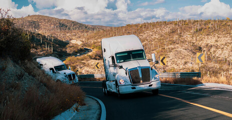 Overtaking trucks on a road curve in a rural landscape at sunset