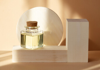 Mock-up of square glass bubble with essential oil in rays of sunlight on background of wooden...