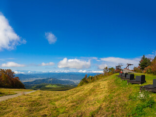 Fototapeta premium Viewpoint overlooking autumnal mountains and town (Zao, Yamagata, Japan)