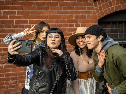 Young Indigenous friends making a selfie outdoors