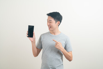 young Asian man using or talking smartphone and mobile phone