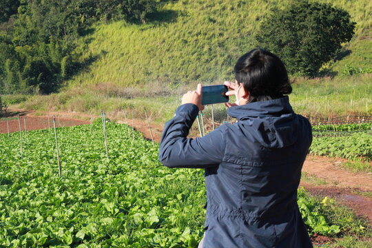 a man taking pictures in the mountains.