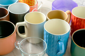 empty mugs of different shapes and sizes on the table