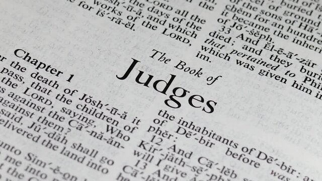Close up shot of Bible Turning to the Book of Judges
