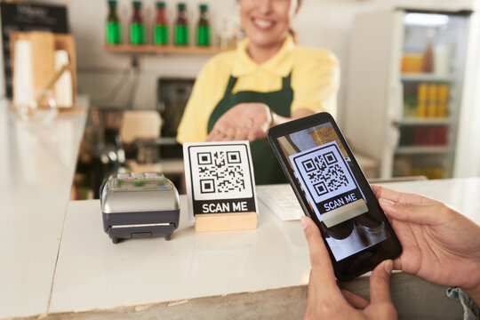 Hands Of Customer Scanning QR Code With Smartphone To Order Take Out Food Online Via App