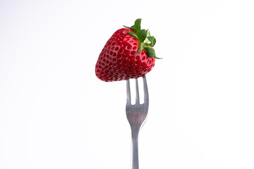 Photo of a strawberry on a fork.
White Background