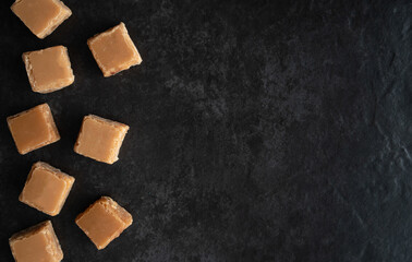 Butterscotch Fudge from Above on a Dark Background with Copy Space