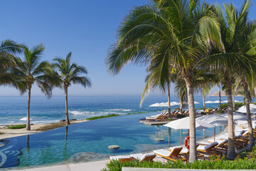 Image of an infinity pool shown against the Pacific Ocean.