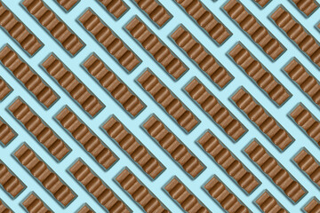 milk chocolate bars pattern isolated on blue background