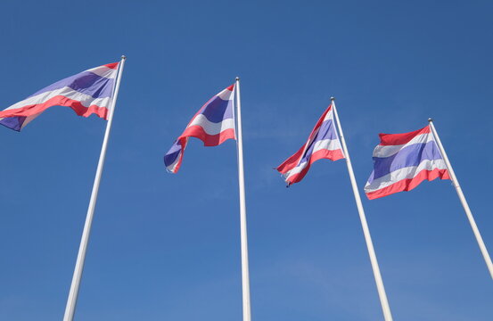 Thai flags waving in blue sky