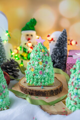 Butter cream cake decorate for Christmas festival with green butter cream and sweet candy, closeup.