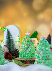 Butter cream cake decorate for Christmas festival with green butter cream and sweet candy, closeup.