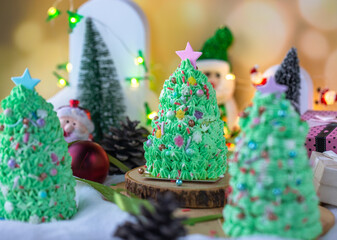 Butter cream cake decorate for Christmas festival with green butter cream and sweet candy, closeup.