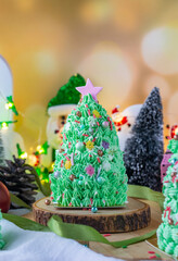 Butter cream cake decorate for Christmas festival with green butter cream and sweet candy, closeup.