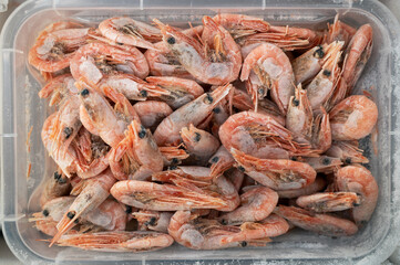 Frozen shrimp in fridge at the fish market. Healthy eating and fish market concept