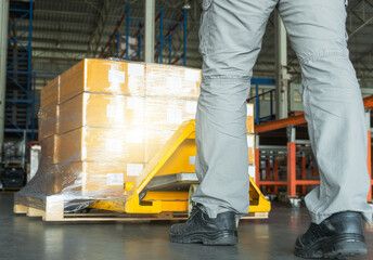 Workers using Hand Pallet Jack Unloading Package Boxes. Commerce Supply Chain. Shipment. Storage Warehouse Cargo Shipping Warehousing Logistics.	