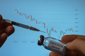 In the hands of a syringe and a vial of Omicron vaccine against the background of a falling stock...