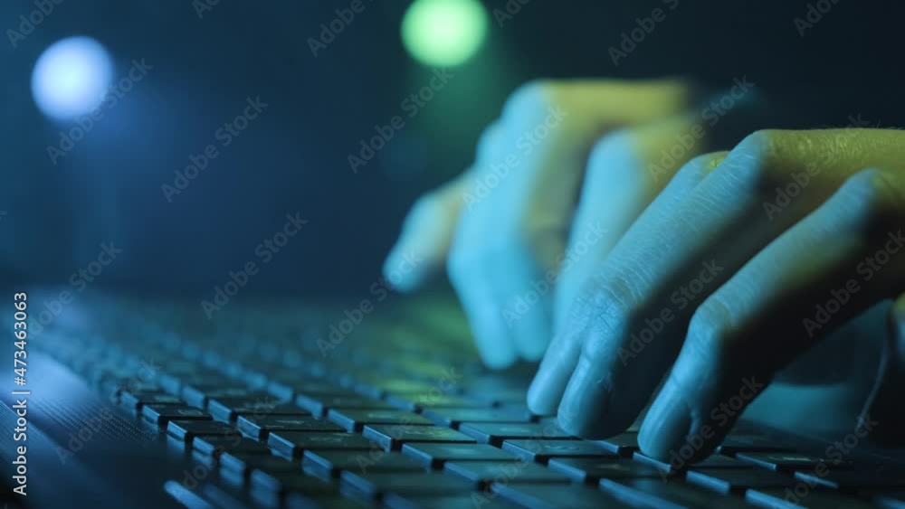 Poster close up image of a hands of female hacker typing on a laptop.
