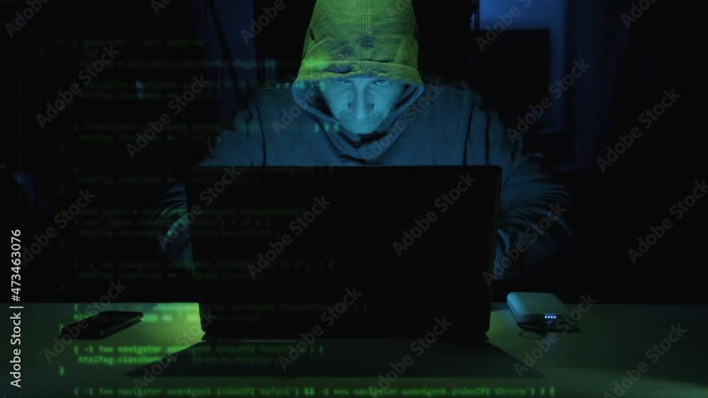 Poster focus male hacker typing security code on laptop computer seen on the left side screen. - close up