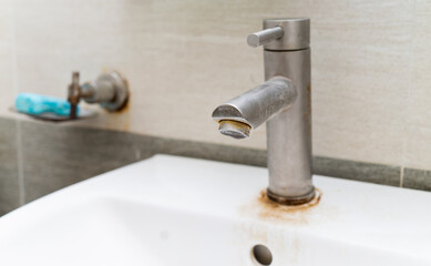 The faucet in the bathroom is rusted.