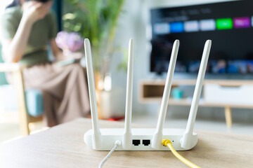 The internet router is placed on the living room table - obrazy, fototapety, plakaty