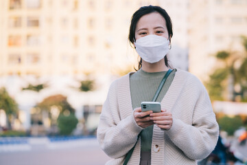 Asian woman wearing a mask while walking on the street