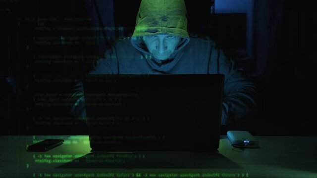 Focus Male Hacker Typing Security Code On Laptop Computer Seen On The Left Side Screen. - close up