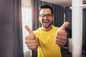 Portrait smart confident smiling millennial man standing at home