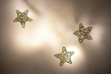 three stars woven from gold wire