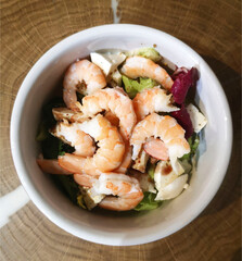 Shrimp salad with lettuce, mozzarella and balsamic sauce. Shrimps and fresh vegetable salad. Healthy food. flat lay. Mediterranean salad view from above
