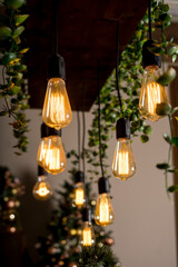 Garland of bulb lamps with modern yellow LED lighting elements. Selective focus.