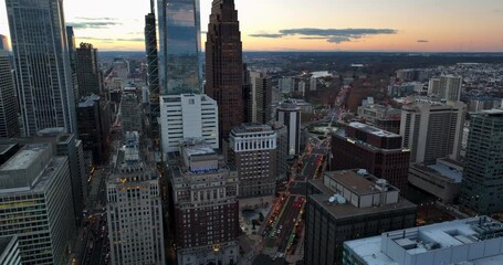 Aerial of highrise skyscrapers in urban America. USA city at sunset. Car traffic below.