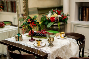 Christmas morning interior with christmas tree Vintage chandelier. White, red and gold balls on the Christmas tree.
