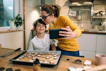 mother and child in kitchen, preparing cookies
